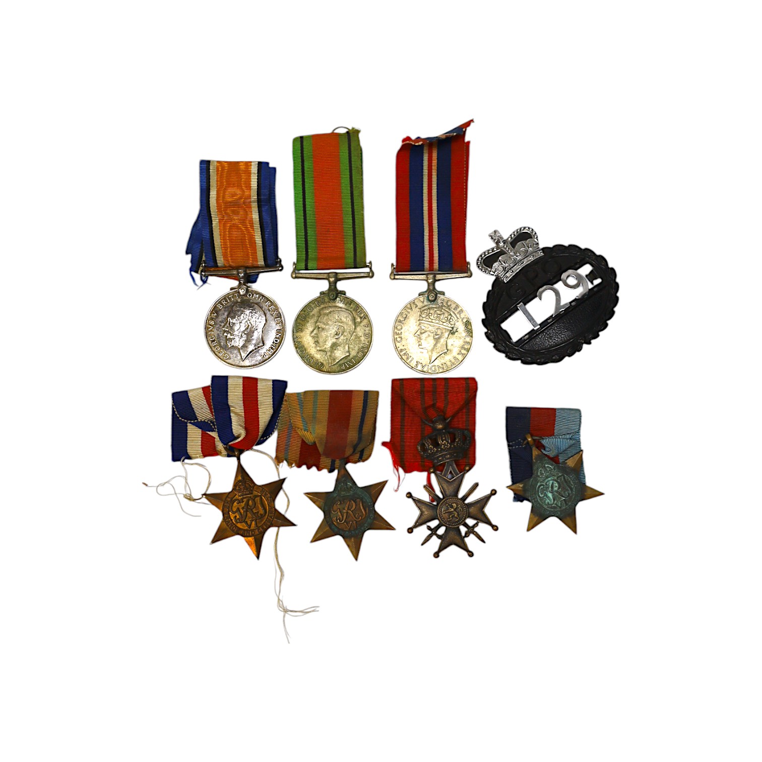 Seven medals including; a First World War British War Medal awarded to PTE. H. Lee DURH. L.I., A 1939-1945 medal, The Defence Medal, the Africa Star, the France and Germany Star, the 1939-1945 Star, plus a GPO cap badge.